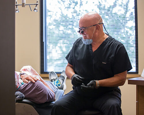 Our Wichita dentist, Dr. Farmer, working with a patient